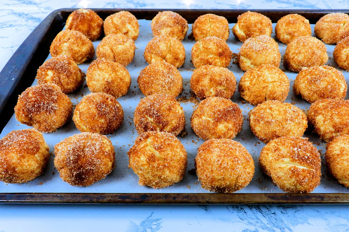 Cinnamon roll dough balls on a baking pan