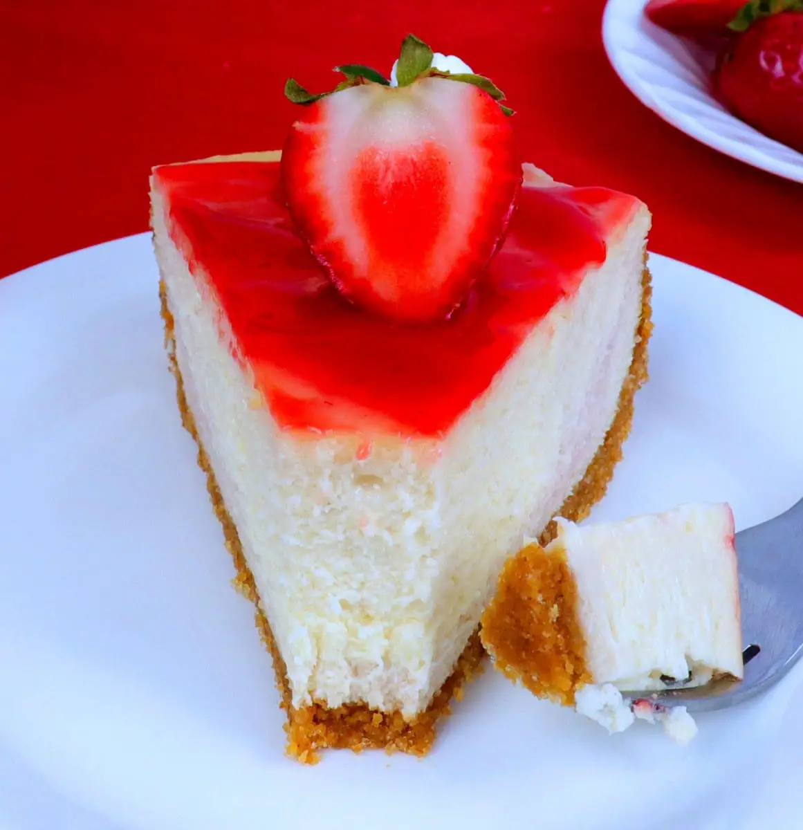 Bite out of cheesecake on plate