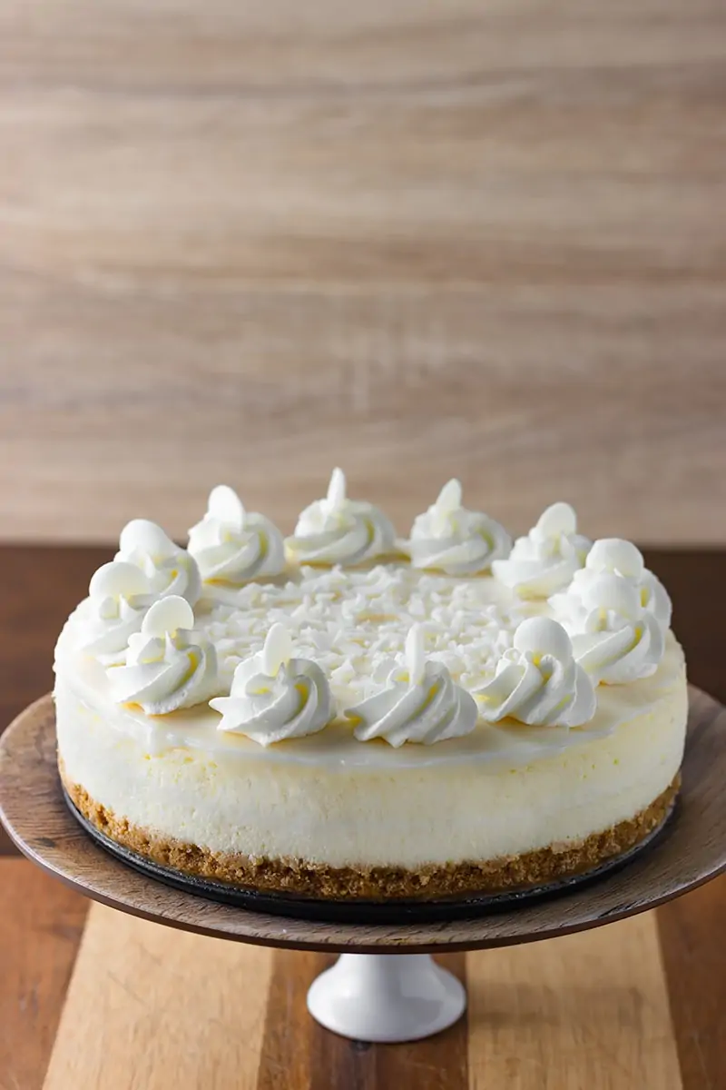 White Chocolate Cheesecake with whipped cream and white chocolate ganache