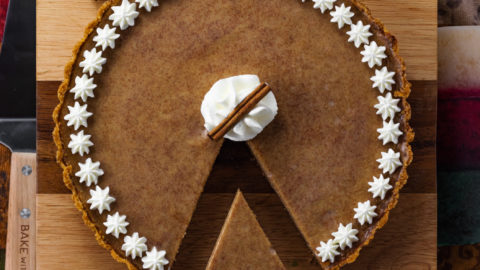 Cinnamon Pie with whipped cream on wood board
