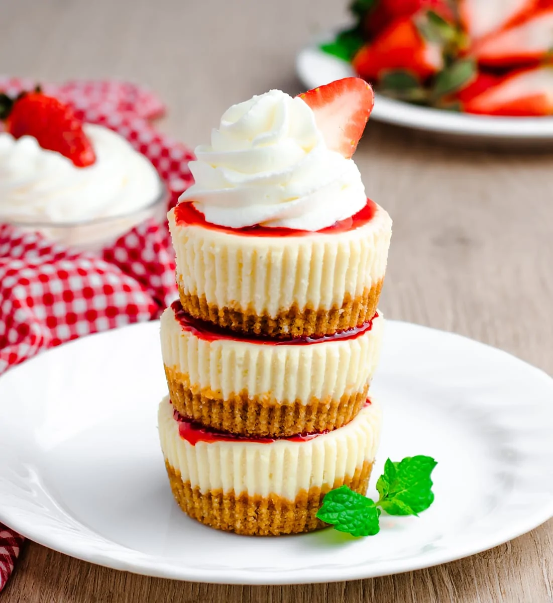 Mini Strawberry Cheesecakes Stacked on a Plate