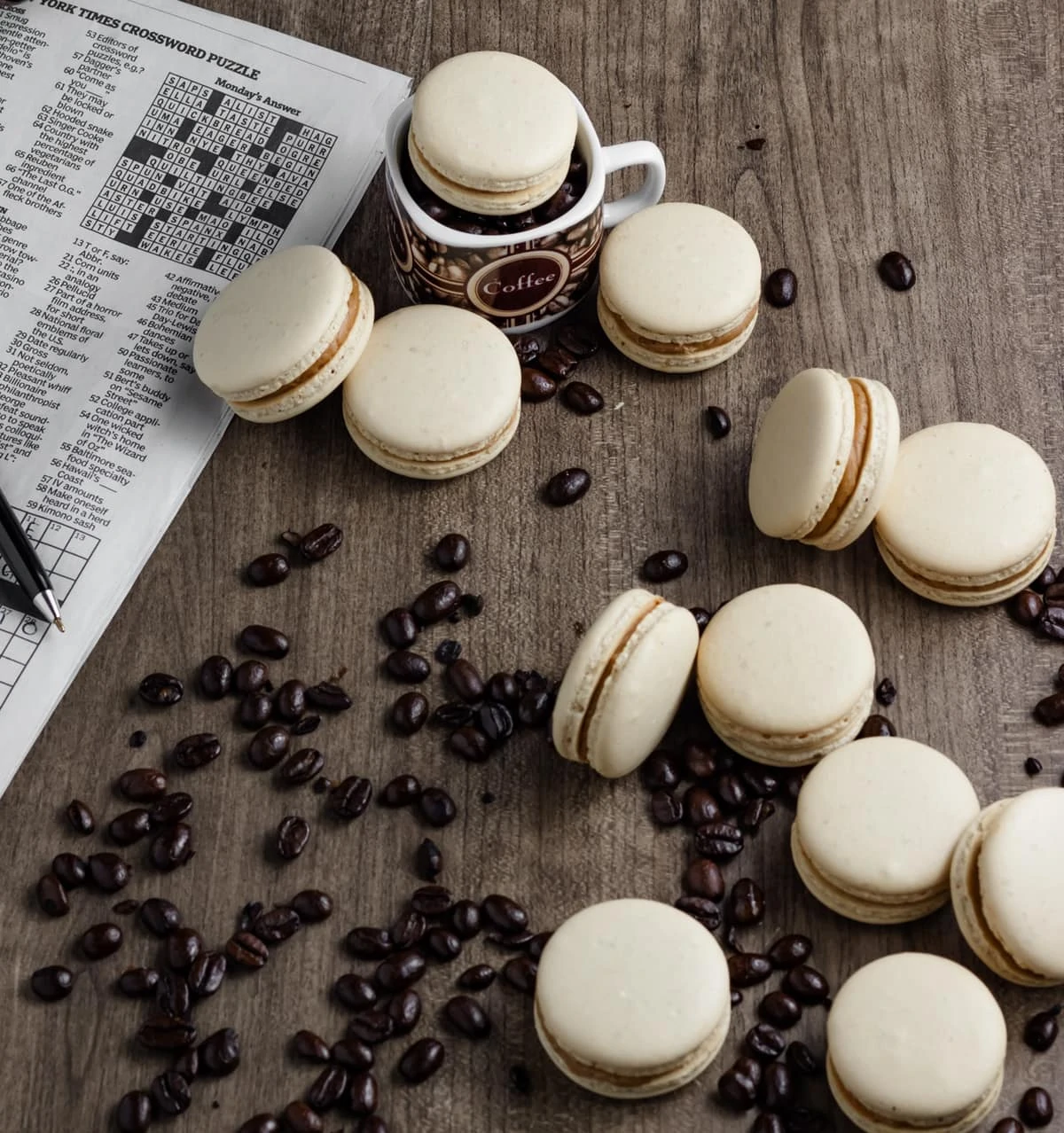 Coffee Macarons on table with crossword puzzle