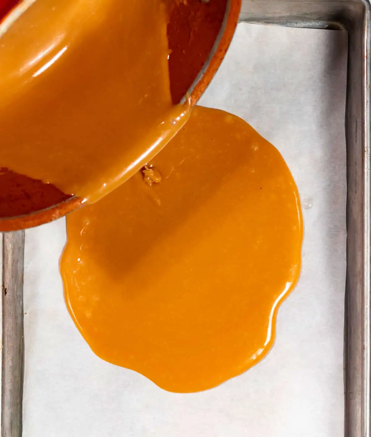 Pouring toffee onto baking sheet