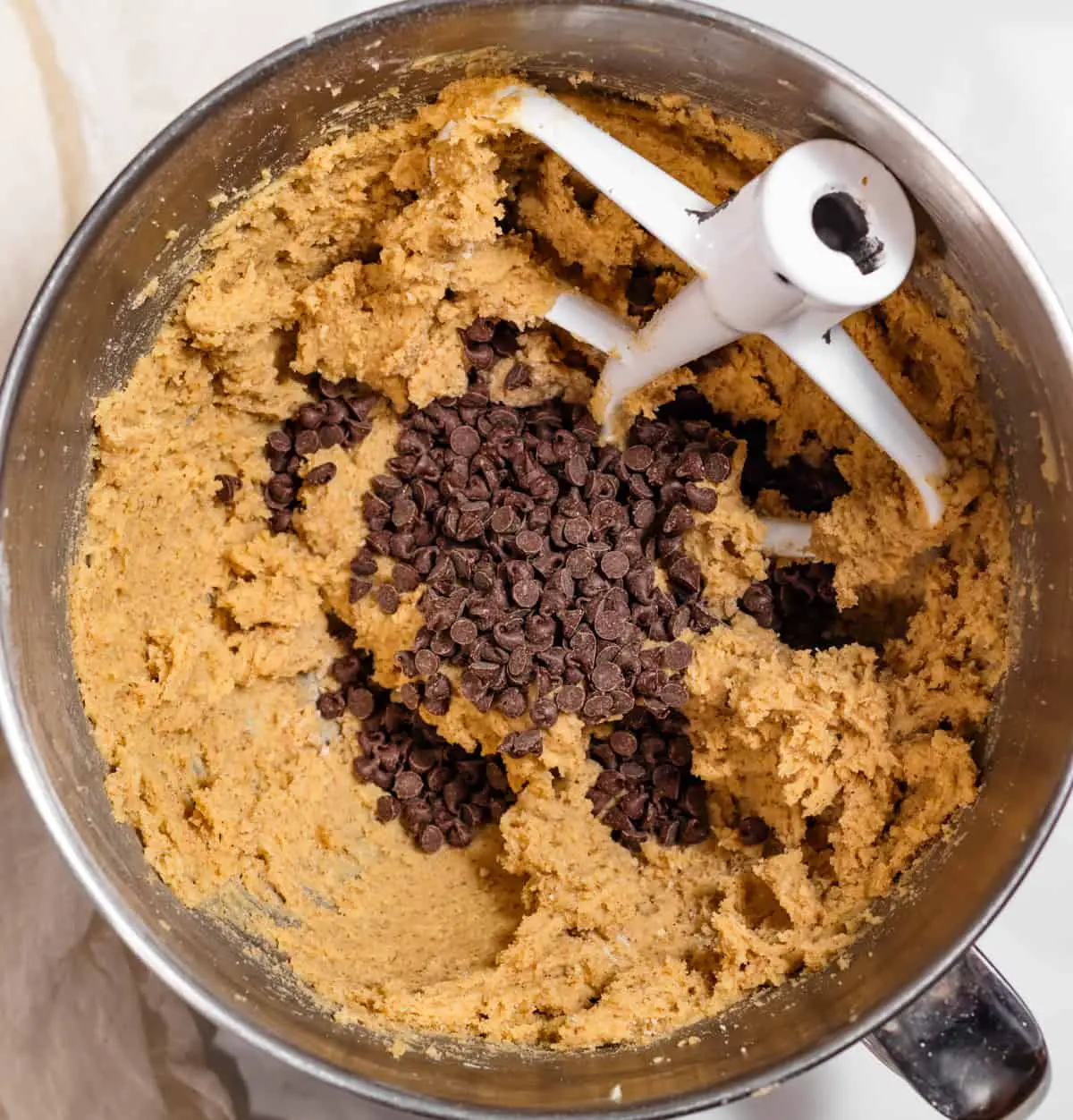 cookie dough in mixer with chocolate chips