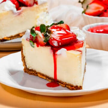 cheesecake slice with strawberries and strawberry sauce