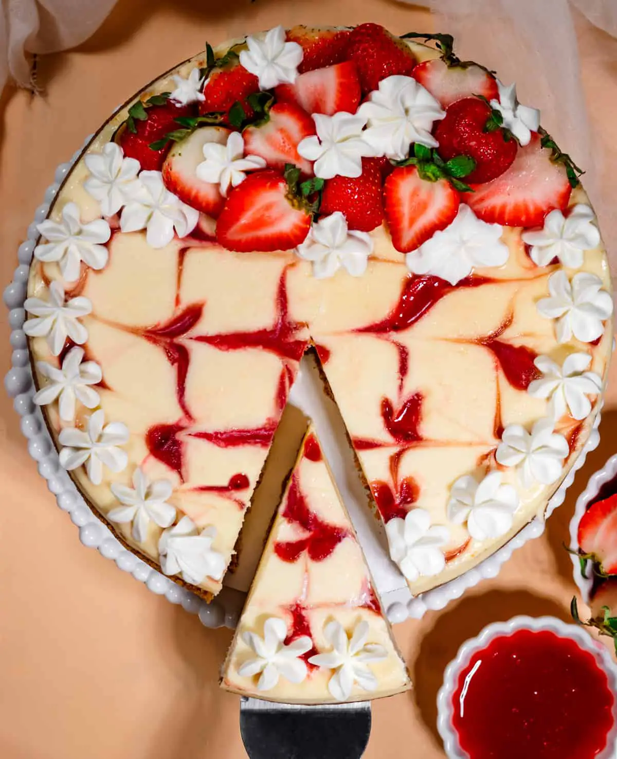 overhead view of cheesecake with strawberry swirl and whipped cream