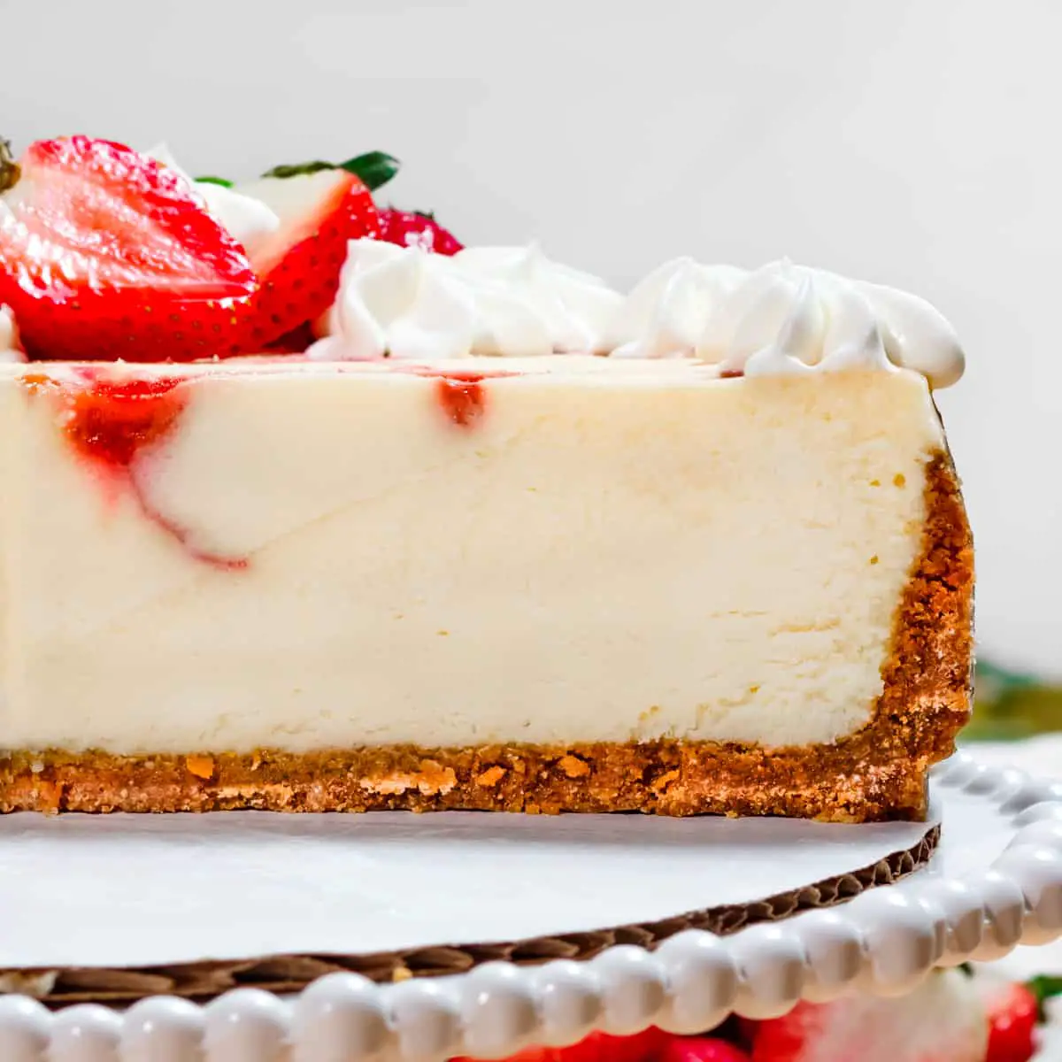 side view of cheesecake with strawberries