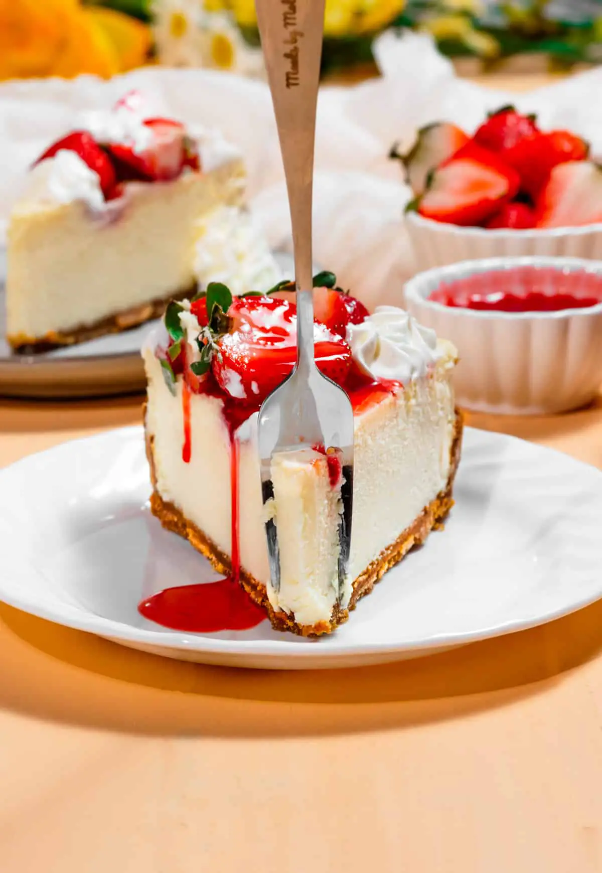 slice of strawberry cheesecake with fork